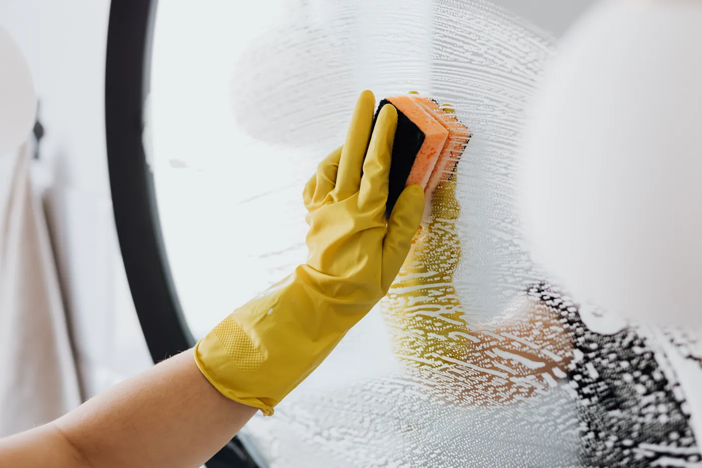 Professional cleaner working on a window